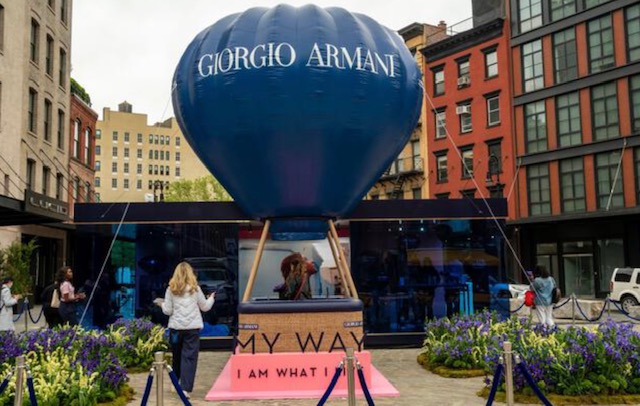 Giorgio Armani My Way activation — large navy balloon vessel above a pink platform and iris garden outside the SoHo boutique
