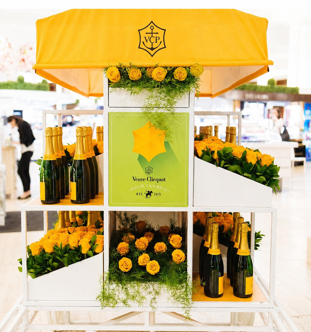 Veuve Clicquot Polo Classic retail cart — yellow canopy with VCP crest, champagne bottles and yellow rose florals